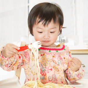 Toddler eating spaghetti