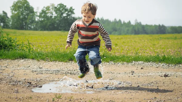 A child playing in the mud and dirt