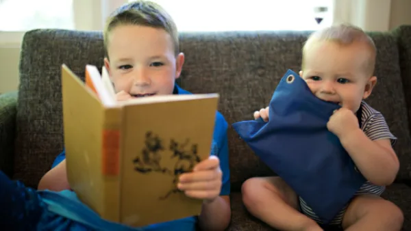 Two kids reading a non-fiction book