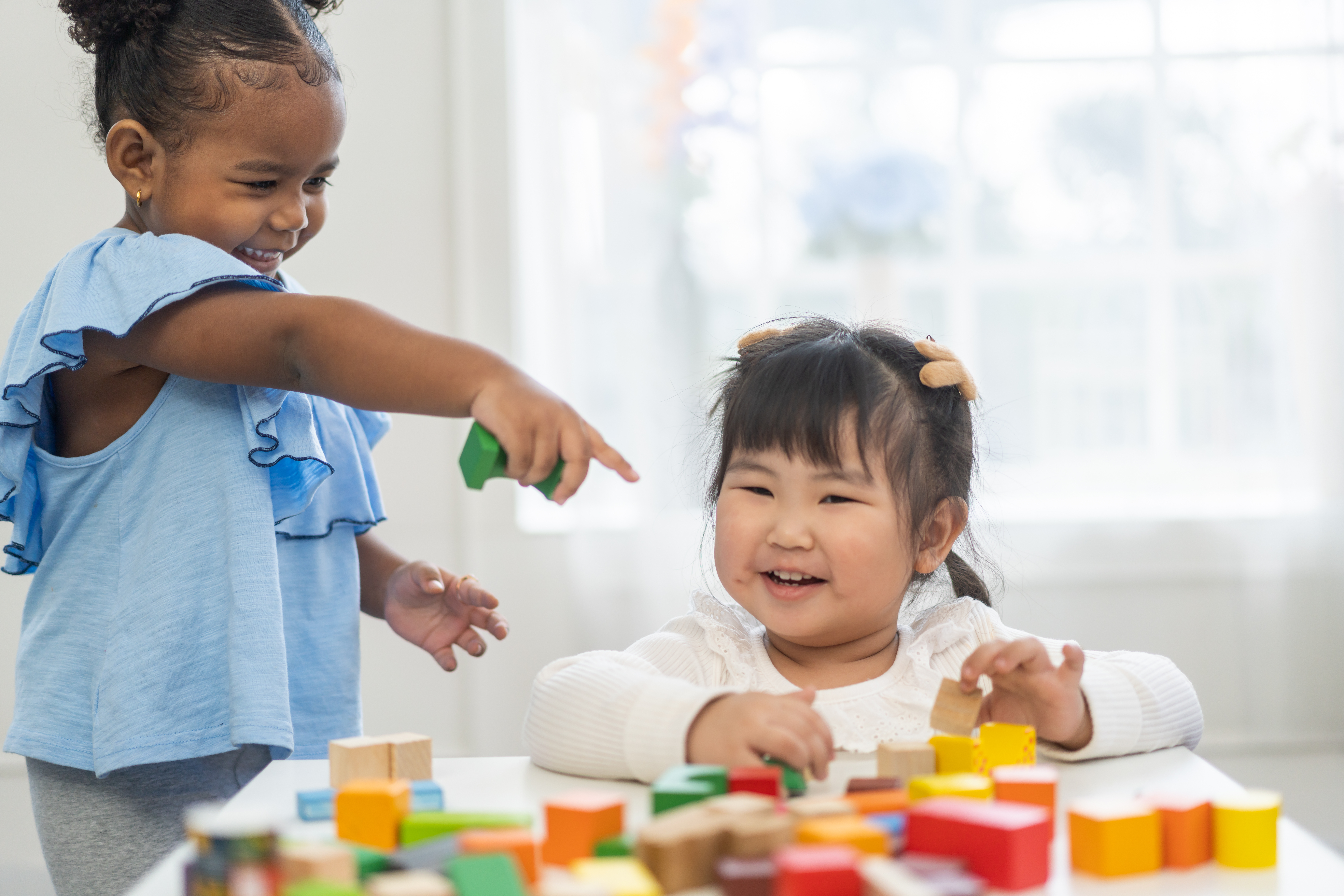 two girls playing with blocks