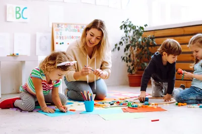 teacher with children writing names