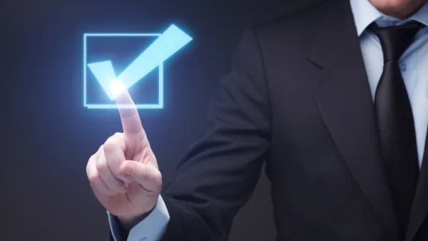 A finger pressing an image of a checkmark