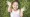 Smiling girl laying in grass