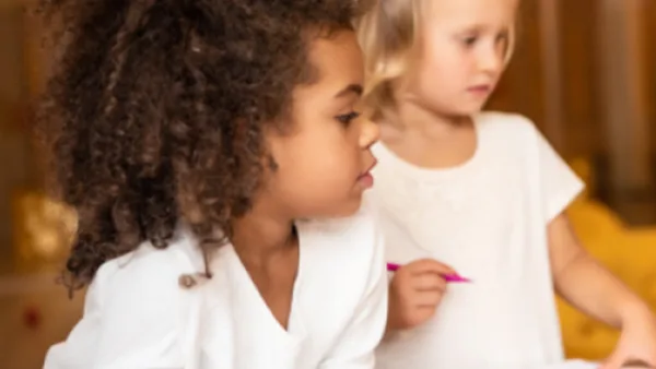 Two kids practicing writing