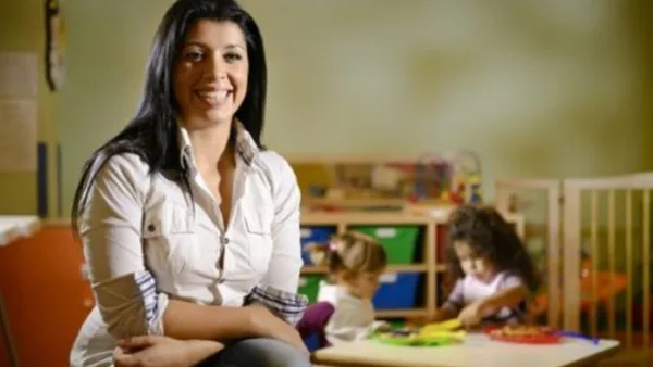 Smiling adult while kids play in background